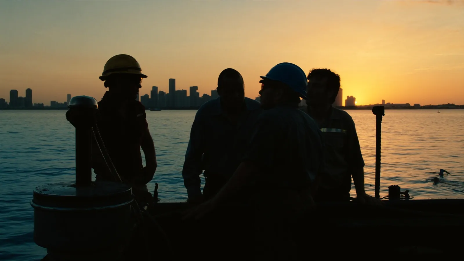 Seawall Repair Miami crew on a work barge at sunrise on Biscayne Bay